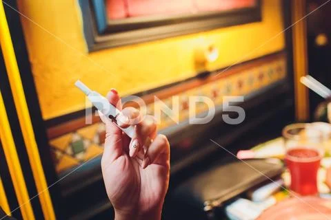 Heat-not-burn tobacco product technology. Man holding e-cigarette in his hand Stock Photos