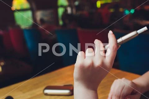 Heat-not-burn tobacco product technology. e-cigarette before smoking. Stock Photos