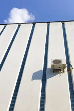 Heat pump. Air conditioning compressor on outside wall. Extra long shot Foto stock