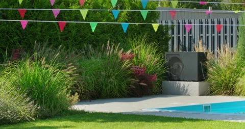 Heat pump next to a private backyard swimming pool surrounded by green plants Stock Footage 308940533