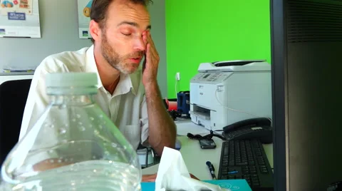 Heat wave at work - Man in office drinking water, sweating Stock Footage 51822096