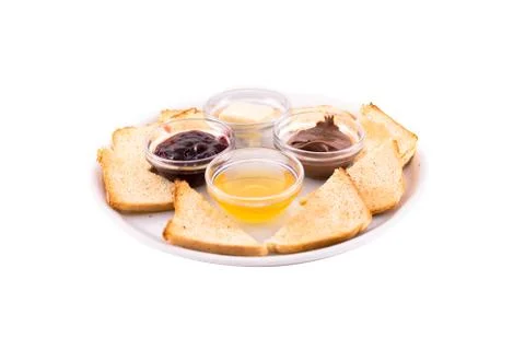 Heated bread (toast) with honey, jam, butter and chocolate Stock Photos