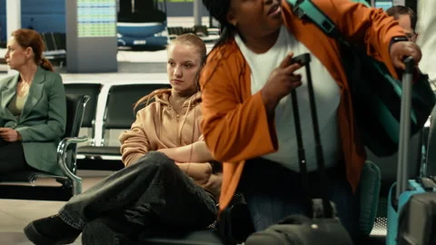 Heated confrontation between two women at busy intercity bus stop Stock Footage 334729783
