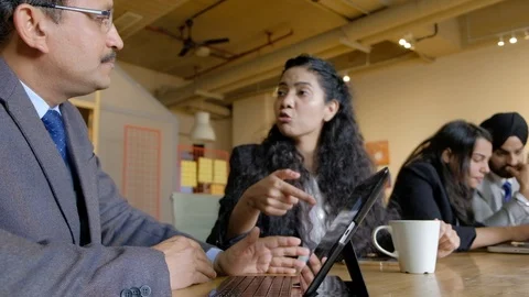 A heated discussion and a busy working team as they hurry come and trying to fig Stock Footage 101936294