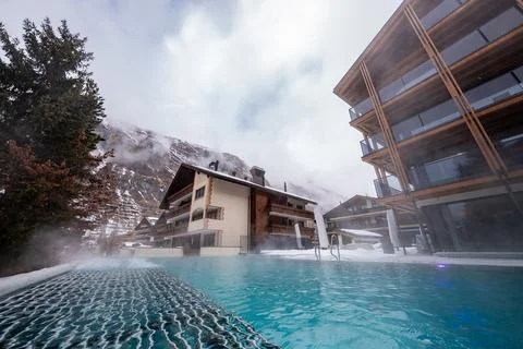 Heated infinity pool and timber glass chalets in Zermatt, Switzerland Stock Photos