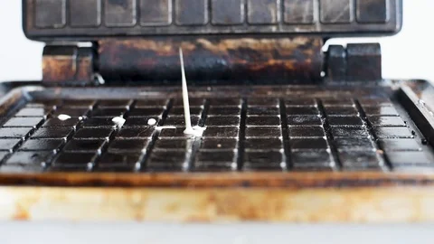 The heated waffle iron baking waffles on a white background Video stock 106874332