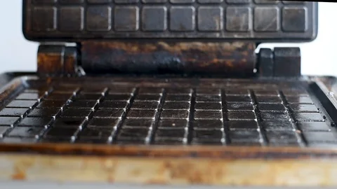 The heated waffle iron baking waffles on a white background Video stock 106874358