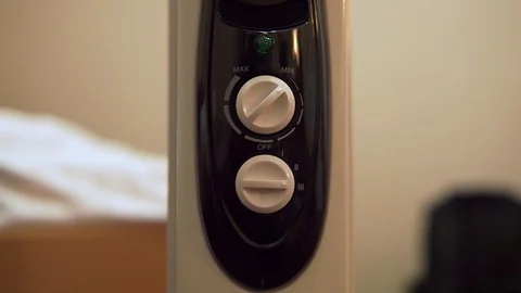 Heater switch. A hand appears that moves the heater switch from the "MIN" positi Stock Footage 103677102