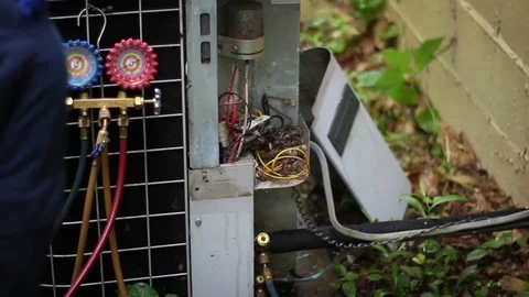Heating and Cooling Service Technician attempting to salvage old air conditioner Stock Footage 75871979