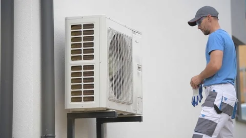 Heating and Cooling Technician Installing New Heat Pump Stock Footage 97228876