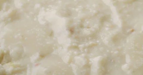 Heating canned clam chowder in a pan Stock Footage 101985632