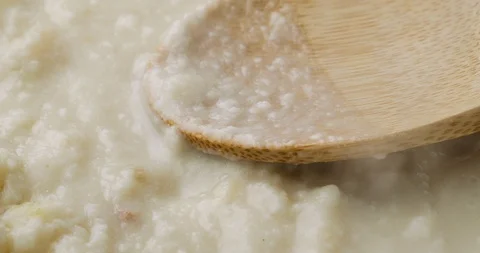 Heating canned clam chowder with a wood spoon on the food Stock Footage 101986448