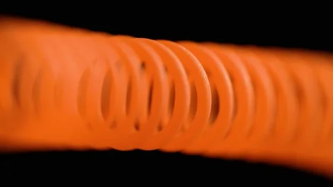 Heating coiled wire close-up on dark background Stock Footage 146064999