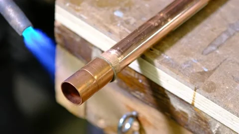 Heating a copper pipe with a torch Stock Footage 139367662