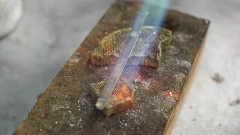 Heating with a flame jet of a metal billet of a silver ring Stock Footage 277883201