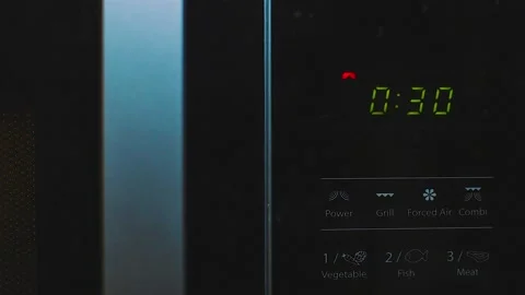 Heating food in a Microwave, countdown timer - close up Stock Footage 130747058