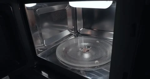 Heating food in a microwave oven, open door Stock Footage 337975456