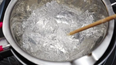 Heating gel for candle making using a water bath method in saucepan Stock Footage 304362865