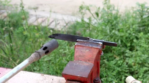 Heating the knife and making his cover Stock Footage 150716360