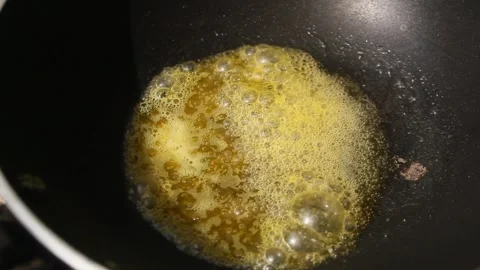 Heating margarine in a frying pan Stock Footage 293075323
