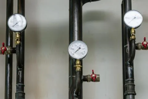 Heating pipes with manometers Stock Photos
