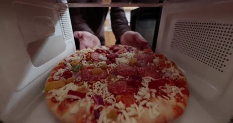 Heating pizza in a microwave oven Stock Footage 153501152