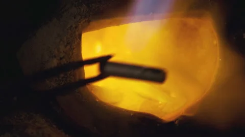 Heating the precious metal to a liquid state in the crucible in the Stock Footage 109096079