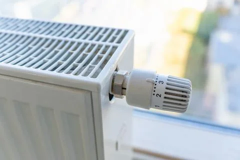 Heating radiator with adjustment knob installed on the middle position in a Stock Photos