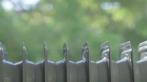 Heating radiator against background of open window from which heat rises. Stock Footage 253873304