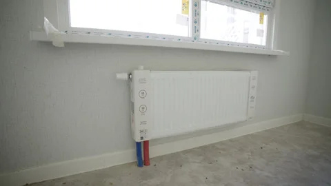 Heating radiator installed beneath newly mounted windows Stock Footage 329745673