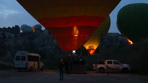 Heating a Red and Yellow Hot Air Balloon in Cappadocia Stock Footage 88690938