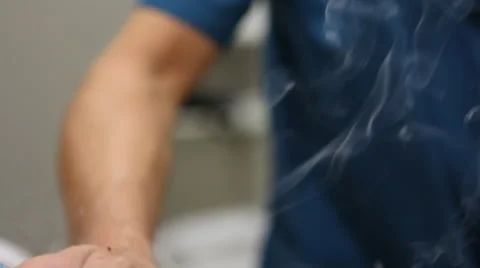 Heating sagebrush cigars Stock Footage 47000827