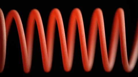 Heating a spiral wire to red close-up on a dark background Stock Footage 146208155