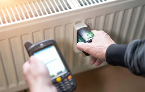 Heating system engineer ist adjusting the digital w-lan network thermometer r Stock Photos