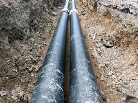 Heating system pipes on the trench 스톡 사진