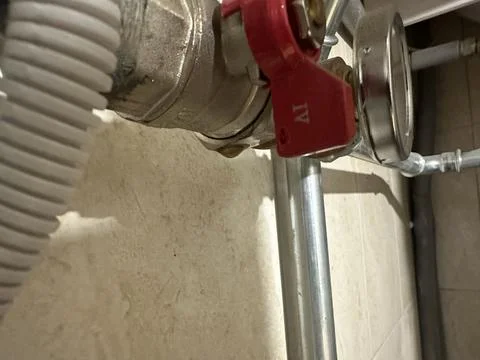 Heating system with red-handled water shut-off valve Stock Photos