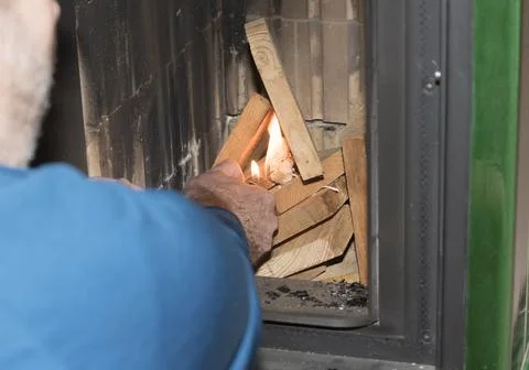 Heating up a tiled stove Stock Photos
