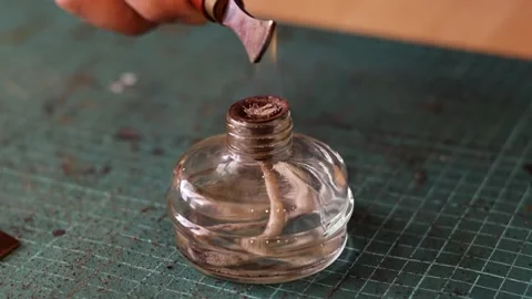 Heating the tool for working with the leather on the fire of an spirit lamp. Stock Footage 150477572