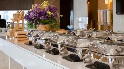 Heating trays on buffet line ready for service. breakfast and lunch buffet fo 写真素材