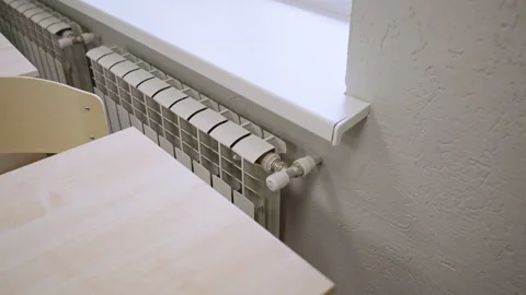 Heating unit stands against textured wall below window Видео 333903848
