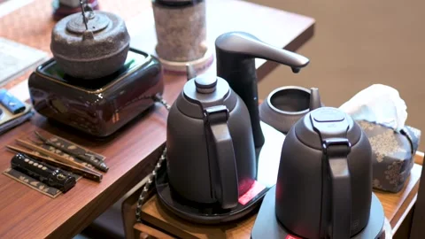Heating Water And Brewing Tea With Modern Teapots On Display Stock Footage 326031354