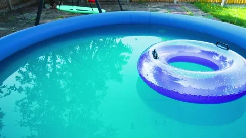 Heatwave home cooling. Backyard inflatable pool helping during record summer Stock Footage 345126071