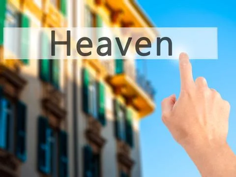 Heaven - Hand pressing a button on blurred background concept on visual scree Stock Photos