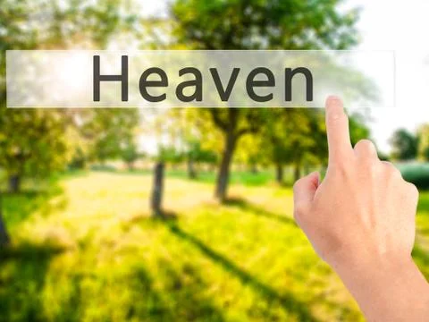 Heaven - Hand pressing a button on blurred background concept on visual scree Stock Photos