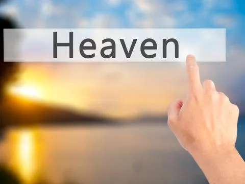 Heaven - Hand pressing a button on blurred background concept on visual scree Stock Photos