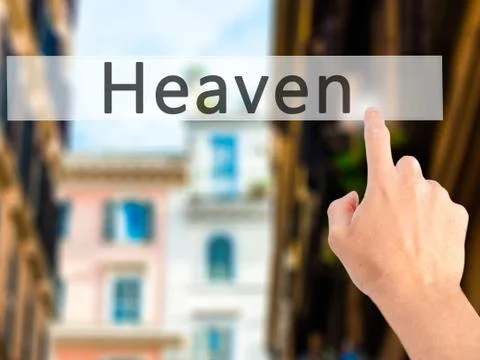 Heaven - Hand pressing a button on blurred background concept on visual scree Stock Photos