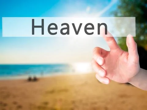 Heaven - Hand pressing a button on blurred background concept on visual scree Stock Photos