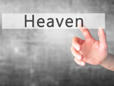 Heaven - Hand pressing a button on blurred background concept on visual scree Stock Photos