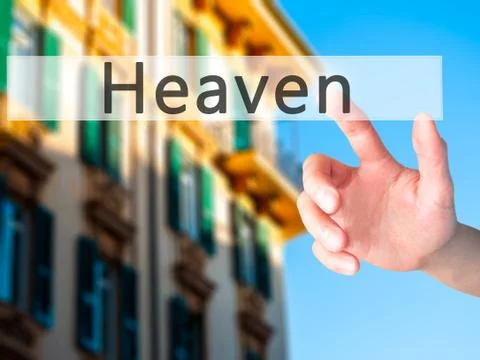 Heaven - Hand pressing a button on blurred background concept on visual scree Stock Photos