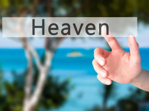 Heaven - Hand pressing a button on blurred background concept on visual scree Stock Photos